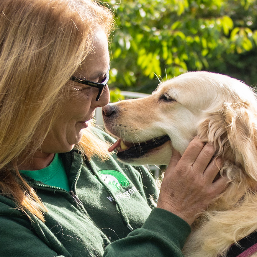 Sue Ketland embracing golden retriever